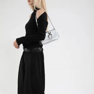 Silver rivet square crossbody bag with black gothic cross and chain on model