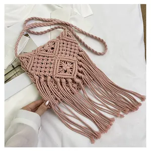 Detail of dusty pink handwoven bag with tassel fringe and braided cotton strap