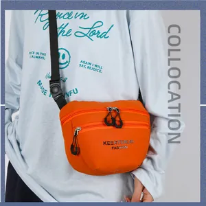 Versatile bright orange nylon crossbody chest bag with zippers and black woven strap