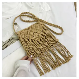 Detailed macro view of the artisanal macrame diamond weave and long cotton tassels