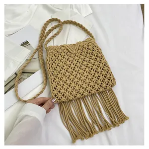 Detailed macro view of bohemian hand-woven cotton bag with elegant long fringe tassels