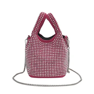 Fuchsia rhinestone bucket bag with silver metal chain strap and dual top handles