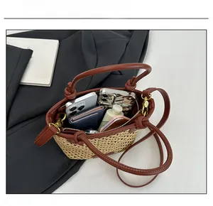 Internal view of the woven bucket bag showing its capacity for smartphones and wallet