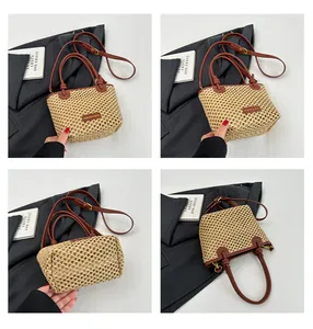 Close-up of beige woven bucket bag with brown leather handles and adjustable strap details