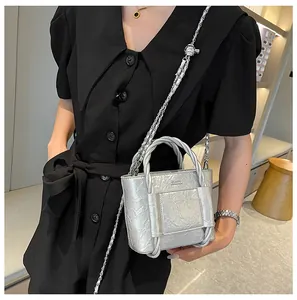 Detail of silver metallic wrinkled bucket bag with chain strap and classic logo