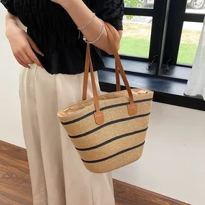 Straw woven striped tote bag with leather straps for summer beach or commute