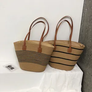 Large summer woven straw tote bag with black stripes and brown leather handles