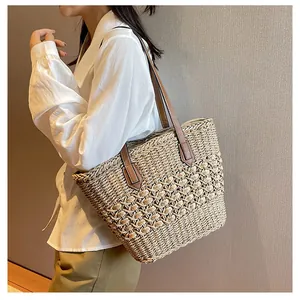 Detailed view of handmade hollow straw woven tote with premium brown leather handles