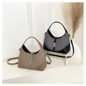 Close-up of texture contrast between fabric and leather on the buckle dumpling bags