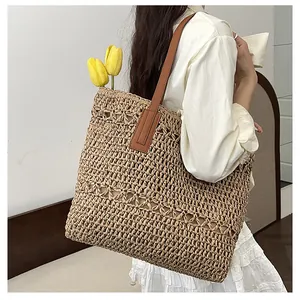 Detailed macro view of woven straw texture and premium brown leather shoulder straps