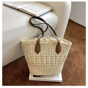 Detailed hollow woven pattern of the straw tote bag with a secure drawstring inner liner