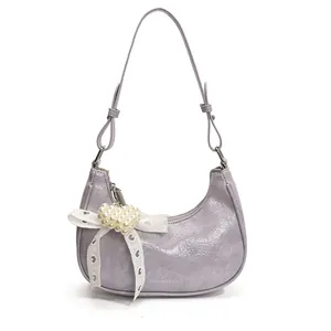 Chic lavender dumpling bag with lace bow and pearl heart pendant on white background