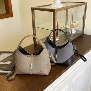Two-tone woven textured dumpling bags with metal locks for casual commute style