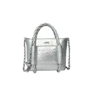Silver metallic mini tote bag with crinkled texture and decorative metal ball chain strap