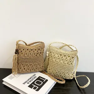 Bohemian style woven straw crossbody bags with hollow floral pattern and tassels