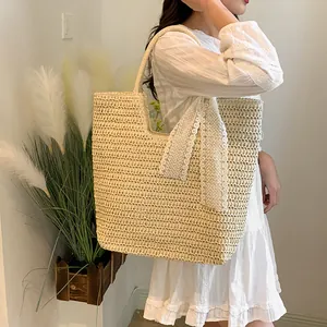 Handwoven beige straw tote bag with elegant white lace bow and large storage capacity