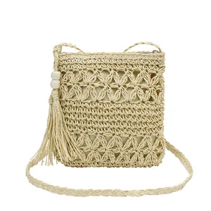 Straw hollow-out shoulder bag with tassels and interior lining for beach vacation style