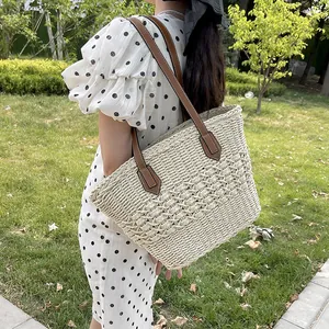 Handwoven straw tote bag with brown leather straps for summer casual and beach commuting