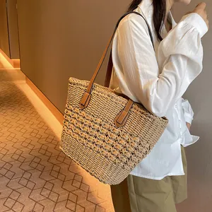 Handwoven straw tote bag with brown faux leather straps for casual summer style