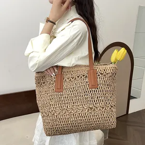 Large straw tote bag with brown leather straps shown on model for summer beach vacations