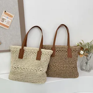 Summer woven straw tote bag with brown leather handles in cream and khaki colors