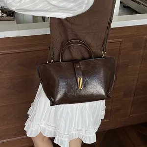 Vintage dark brown tote bag with metallic clasp and pleated leather texture