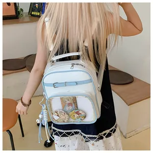 Detail of white and blue Ita bag featuring large clear window for anime badge display