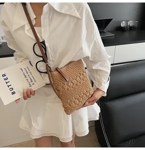 Detail of hollow woven texture and premium zipper on brown straw shoulder tote bag