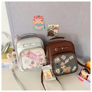 Detail of crossbody ita bag with clear window for displaying anime pins and cards
