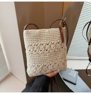 Close-up of hollow crochet texture and brown leather strap on the off-white tote