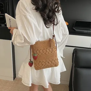 Caramel hollow woven tote bag with cute strawberry charms and brown leather strap