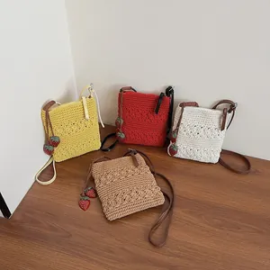Handmade crochet tote bag with hollow flower patterns and cute strawberry charms