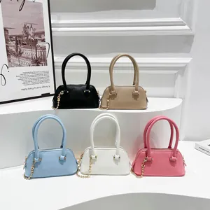 Five small square shell shoulder bags in various colors with gold chain straps and top handles
