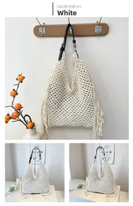 Detail of hand-woven hollow knit tote bag in off-white with long fringe and black strap
