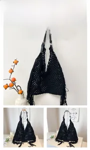 Close-up of black hollow crochet mesh bag featuring fringe tassels and leather strap