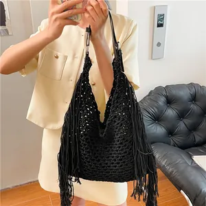 Handmade black crochet tote bag with fringe details and woven hollow mesh pattern