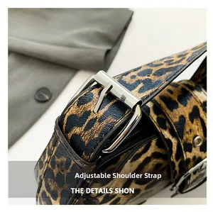 Detailed macro view of adjustable leather strap with silver metal buckle on leopard handbag