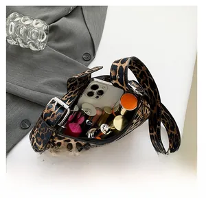 Top view of leopard print shoulder bag interior showing phone and cosmetics capacity