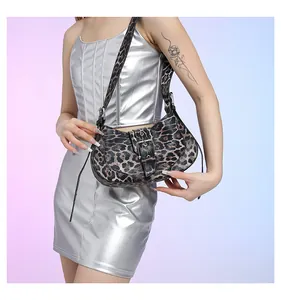 Detail of leopard print crossbody bag with silver buckle and metallic fashion styling