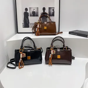 Three minimalist faux leather satchel bags in black, brown, and dark coffee with bear charms