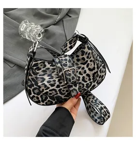 Detail of vintage leopard print crossbody bag with silver buckle and stylish strap