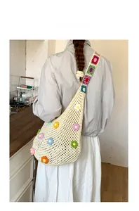 Detail of cream crochet bag featuring colorful 3D flowers and granny square strap