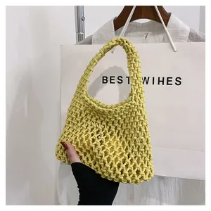Close-up of yellow handmade woven bag showing diamond hollow mesh and cotton rope texture