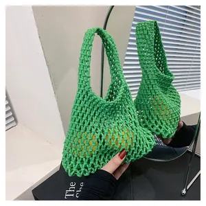 Macro detail of green handmade crochet mesh tote bag featuring a hollow knit structure