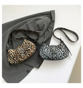 Detailed comparison of brown and grey leopard print hobo bags with metallic buckle details