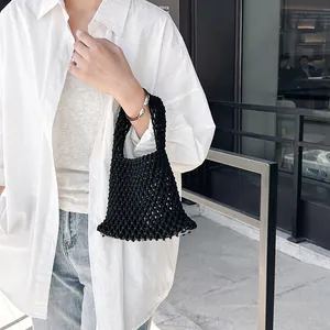 Handmade black woven tote bag with hollow knot design for stylish summer street fashion
