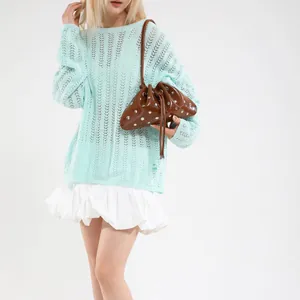 Brown leather bucket bag with silver studs and drawstring, styled over mint knit top