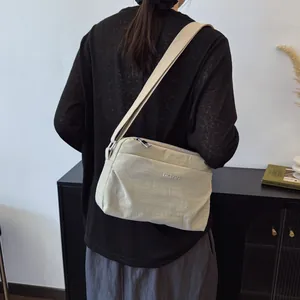 Minimalist beige nylon crossbody bag for women with adjustable strap for casual daily use