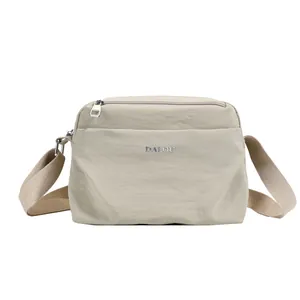 Waterproof beige nylon crossbody bag with adjustable wide shoulder strap for women