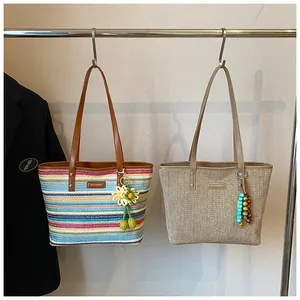 Detail of hand-woven summer tote bags featuring rainbow stripes and sunflower charms